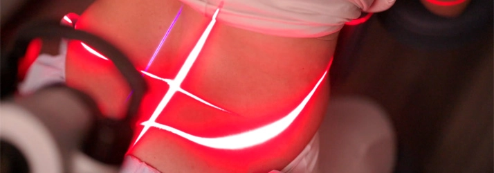 Laser therapy on a persons lower back.
