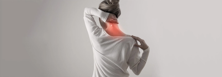 Chiropractic Waukee IA Neck Pain A person holding their neck in pain.